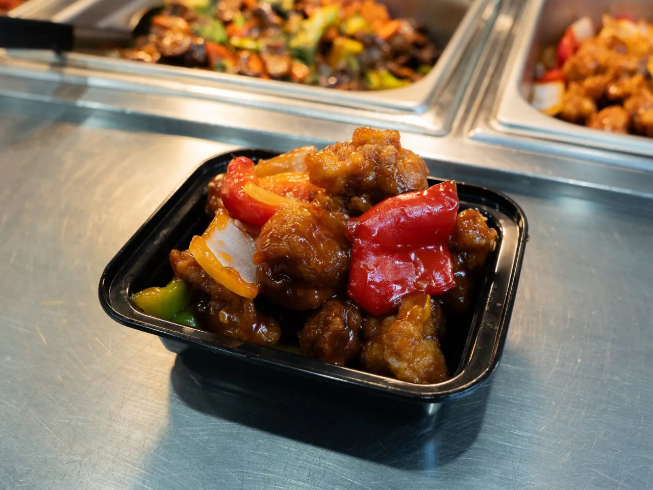 Crispy chicken in sweet and sour sauce with bell peppers at Kennys Wok, a Chinese Restaurant in Philadelphia