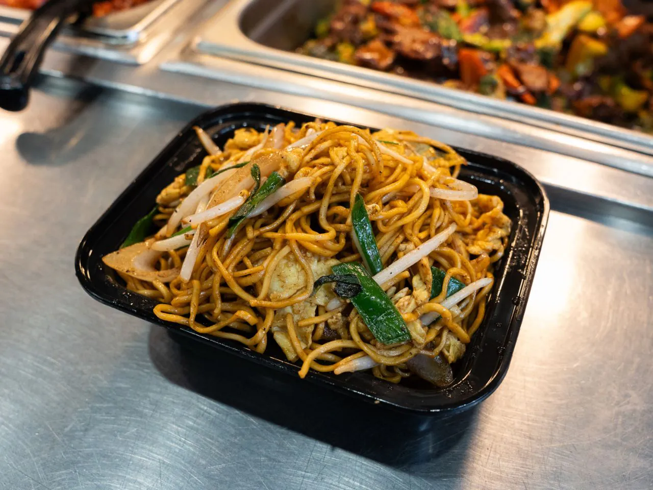 Stir-fried egg noodles with chicken and vegetables at Kennys Wok, a Chinese Restaurant in Philadelphia
