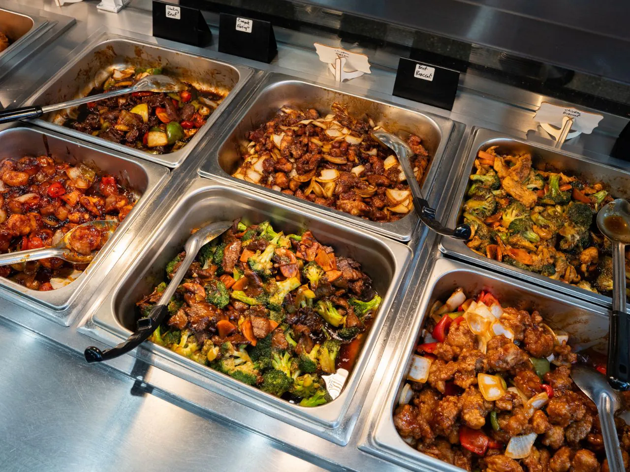 Assorted buffet entrees including orange chicken and beef with broccoli at Kennys Wok, a Chinese Restaurant in Philadelphia