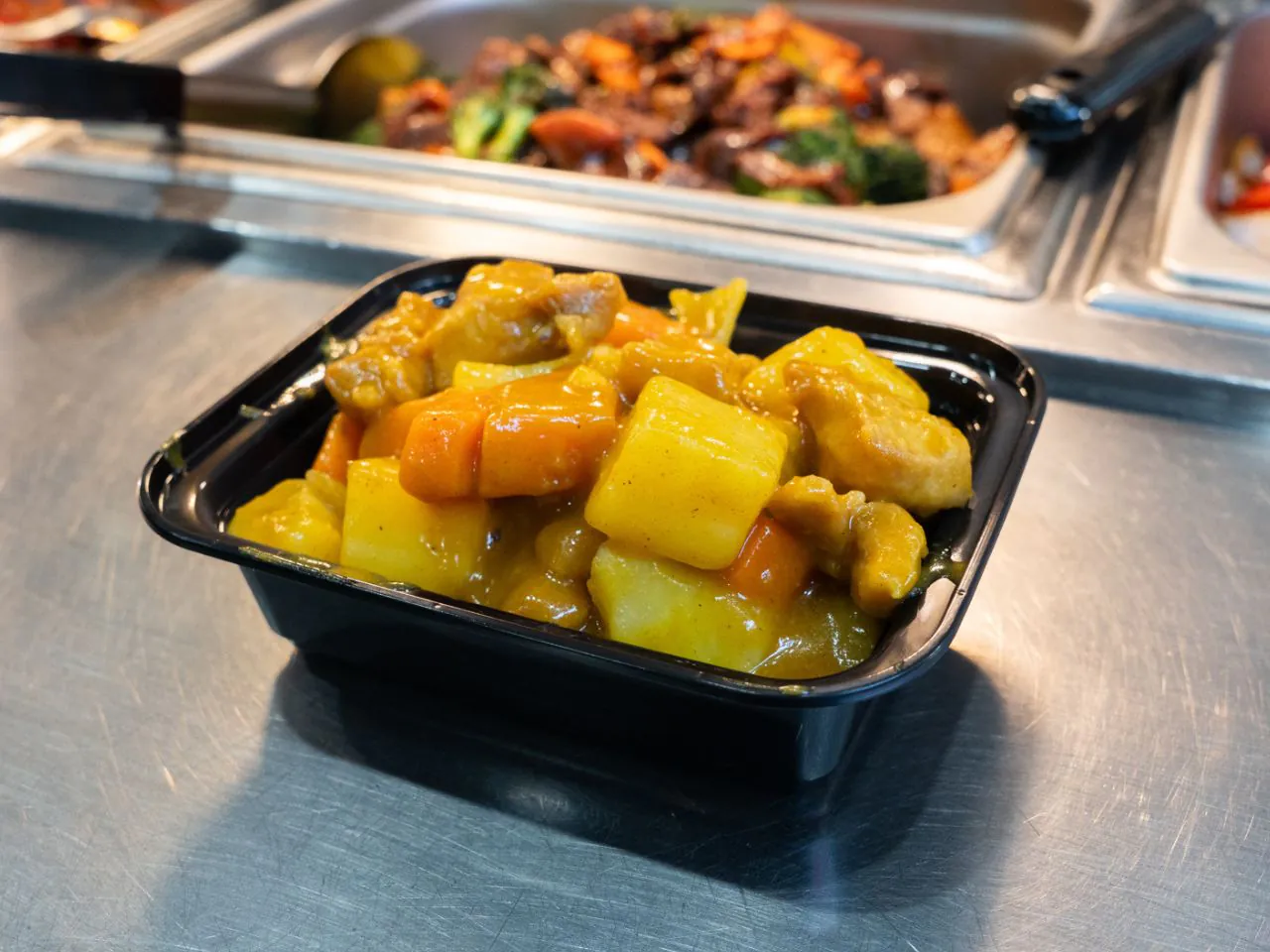 Chicken and potatoes in fragrant yellow curry sauce at Kennys Wok, a Chinese Restaurant in Philadelphia